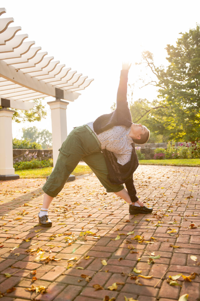 artistic photo of person doing yoga with sun behind at sharon mills county park in manchester michigan