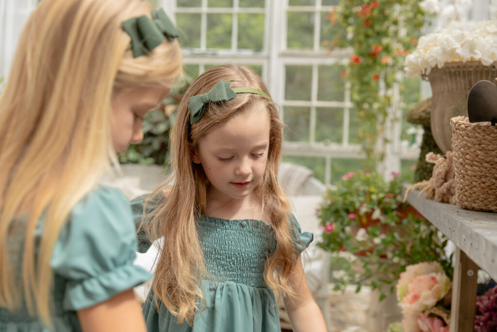 Sisters explore together in beautiful greenhouse at Rustic Wild Arrow in Brooklyn Michigan