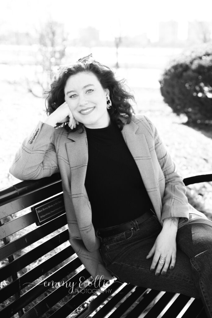 woman sits on bench outside belle isle conservatory in detroit michigan