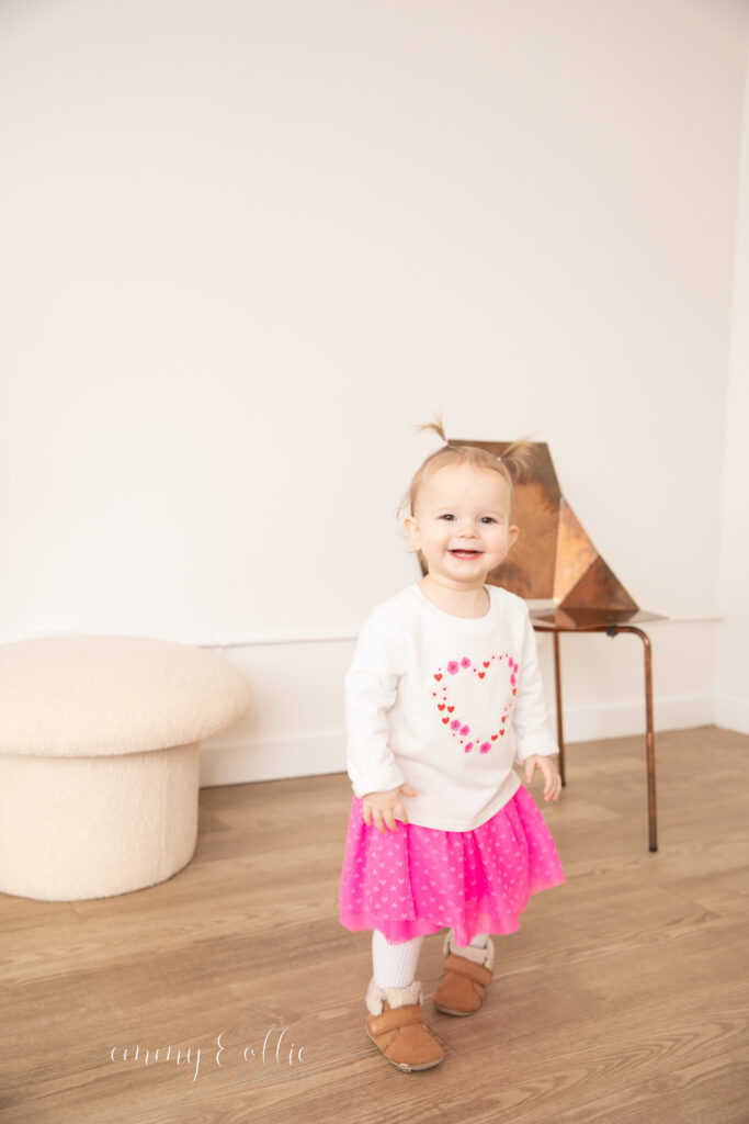 toddler girl smiles at camera at studiostudio in ann arbor michigan