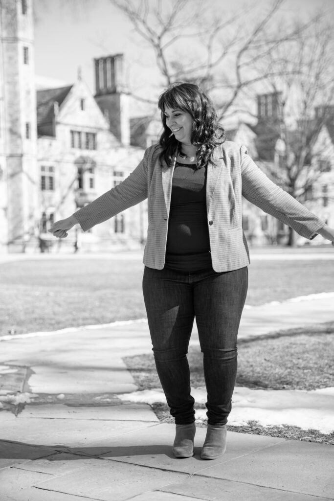 black and white photo of woman dancing in university of michigan law quad