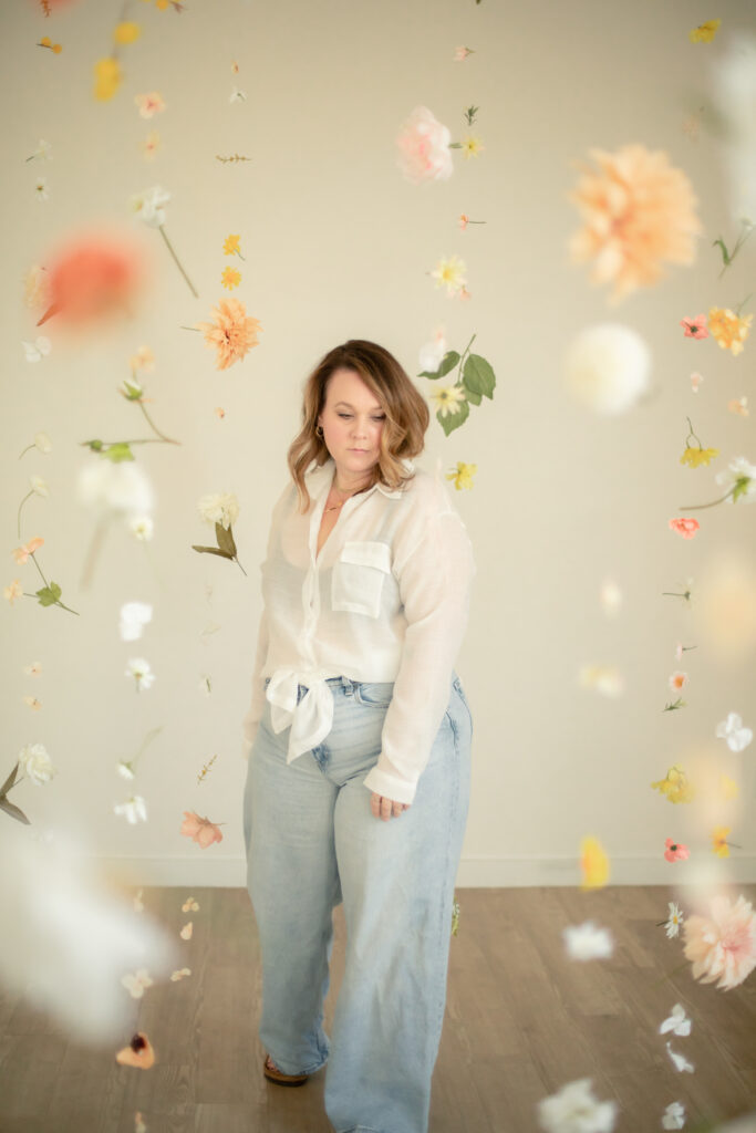 Woman walks towards camera through floating floral installation at studiostudio in ann arbor michigan