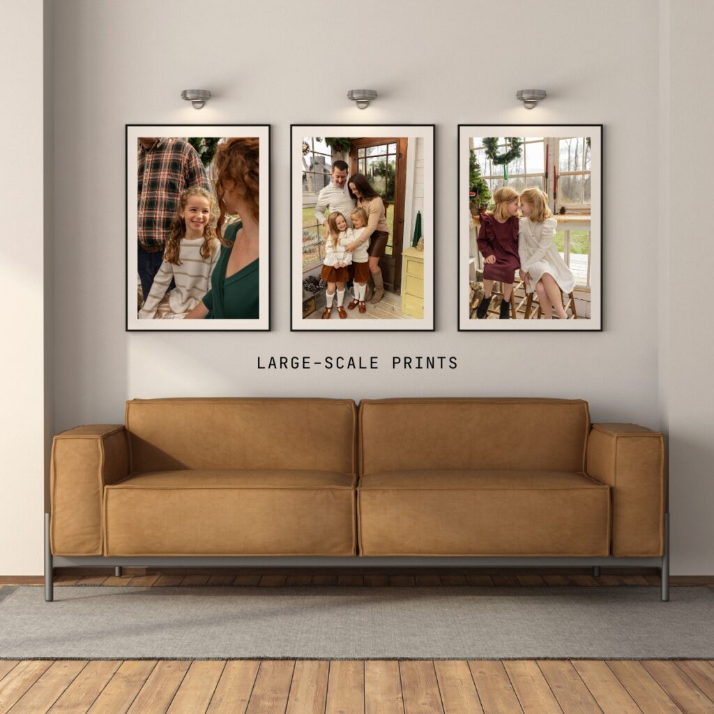 Three framed photos of girls at christmas hang on a wall above a sleek brown leather couch