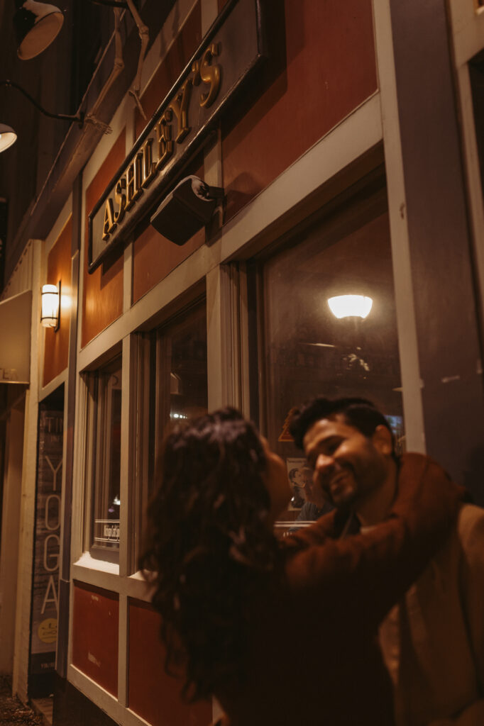 man and woman lean against outside of ashley's building in ann arbor michigan