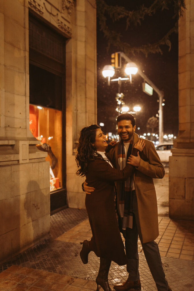 man and woman laugh and dance together at entrance to nickels arcade in ann arbor michigan