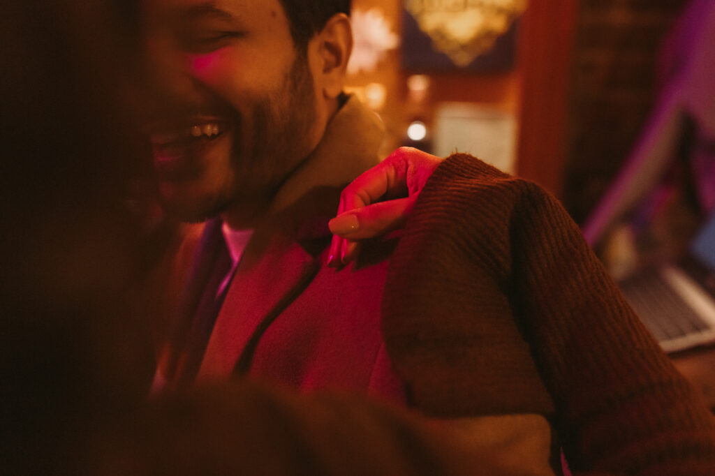 close up image of woman's hand on a man's shoulder