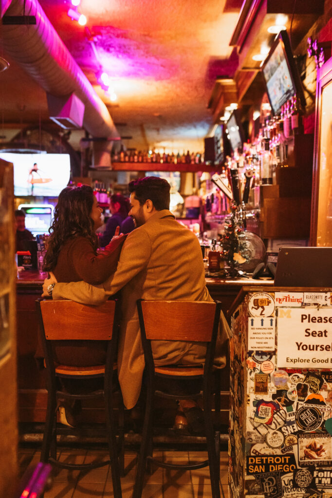 Man and woman sit at the bar at Ashley's