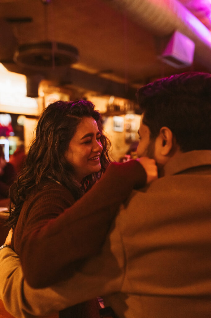 Woman puts arm around shoulder of husband and laughs at ashley's in ann arbor