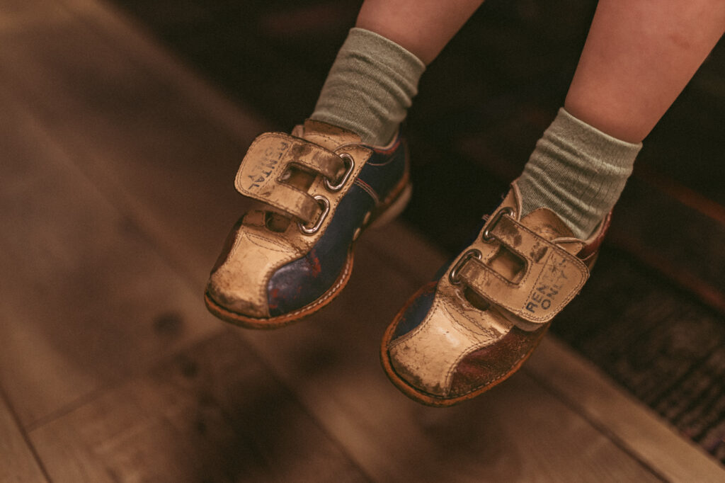 close photo of a girl wearing vintage bowling shoes